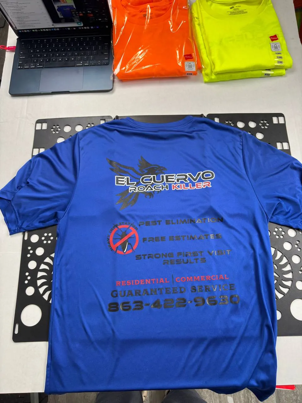 Full-back El Cuervo Roach Killer plastisol print on a blue shirt